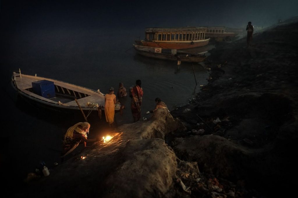 Fotógrafos tramposos. Plano general, color. Hindus preparando los rezos a la orilla del Ganges.